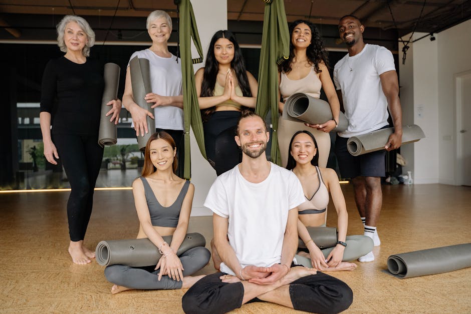 Smiling people of different ages in a light-filled yoga studio